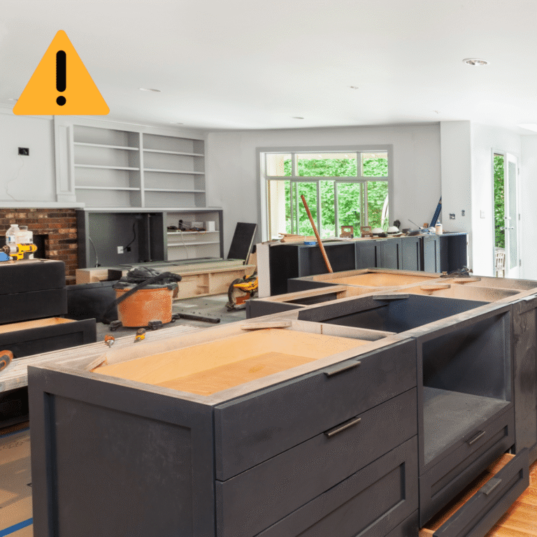 A kitchen renovation in progress with an unfinished island and a caution warning icon overlay.